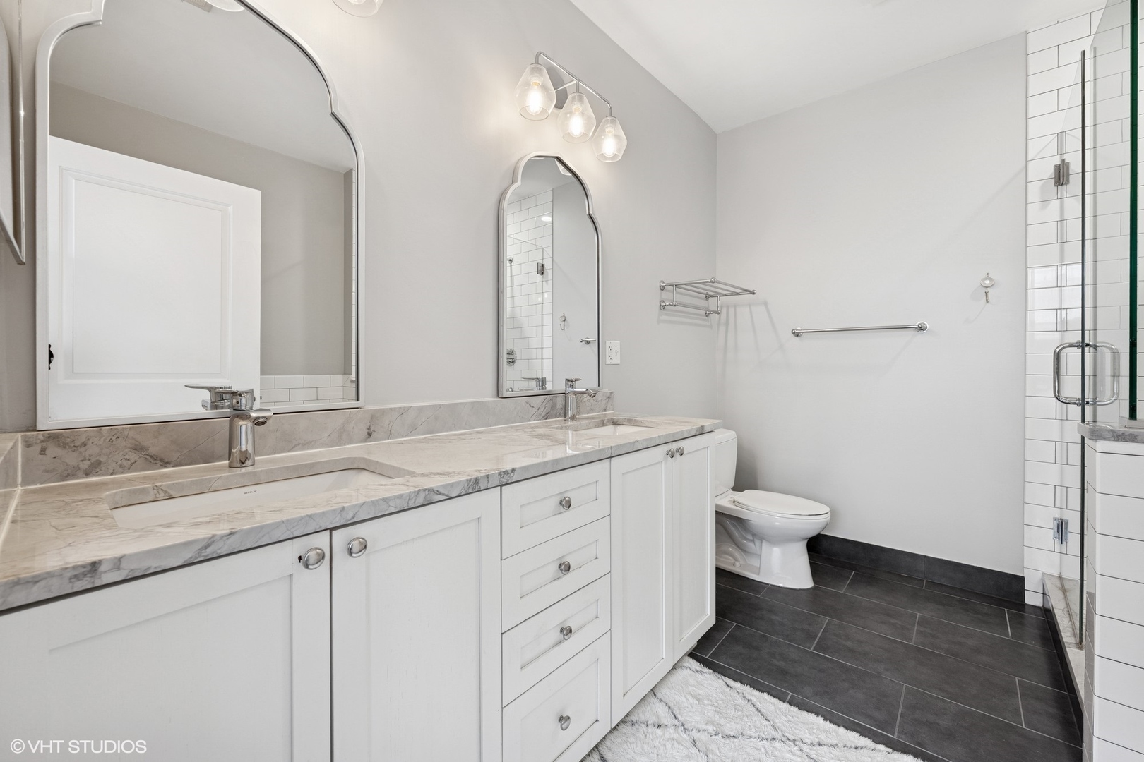 950 West Monroe Street, Unit 410 Chicago, IL 60607 - Photo 19 of 23 a bathroom with a granite countertop sink mirror and toilet