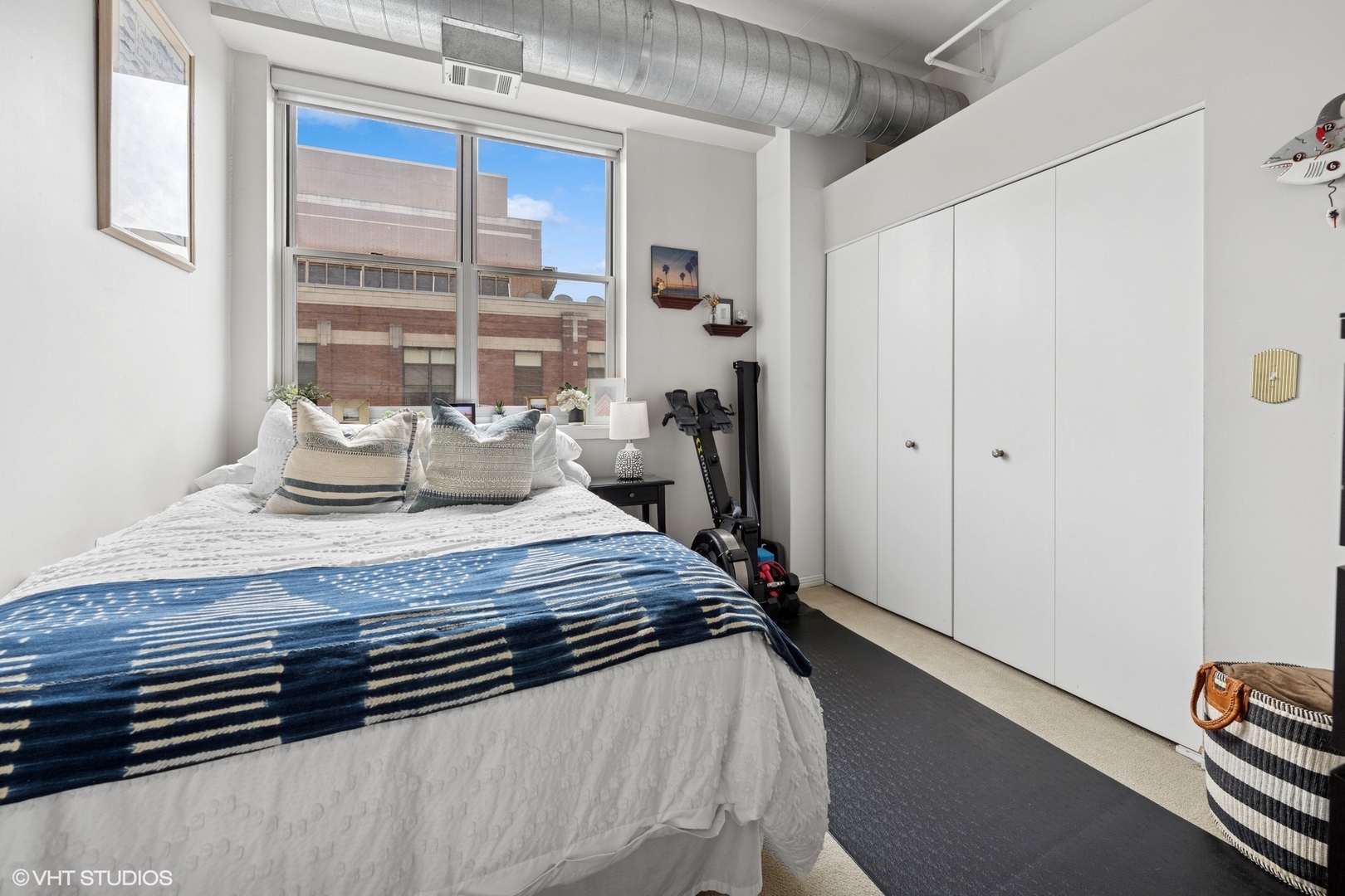 950 West Monroe Street, Unit 410 Chicago, IL 60607 - Photo 21 of 23 a bedroom with a bed and wooden floor