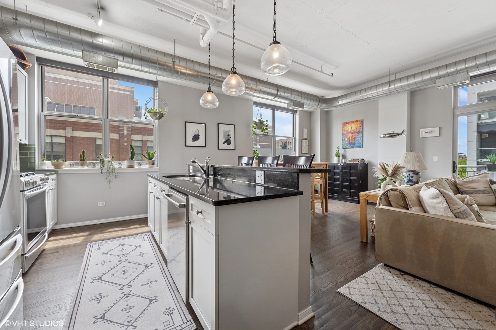 950 West Monroe Street, Unit 410 Chicago, IL 60607 - Photo 3 of 23 a kitchen with stainless steel appliances granite countertop a sink and cabinets