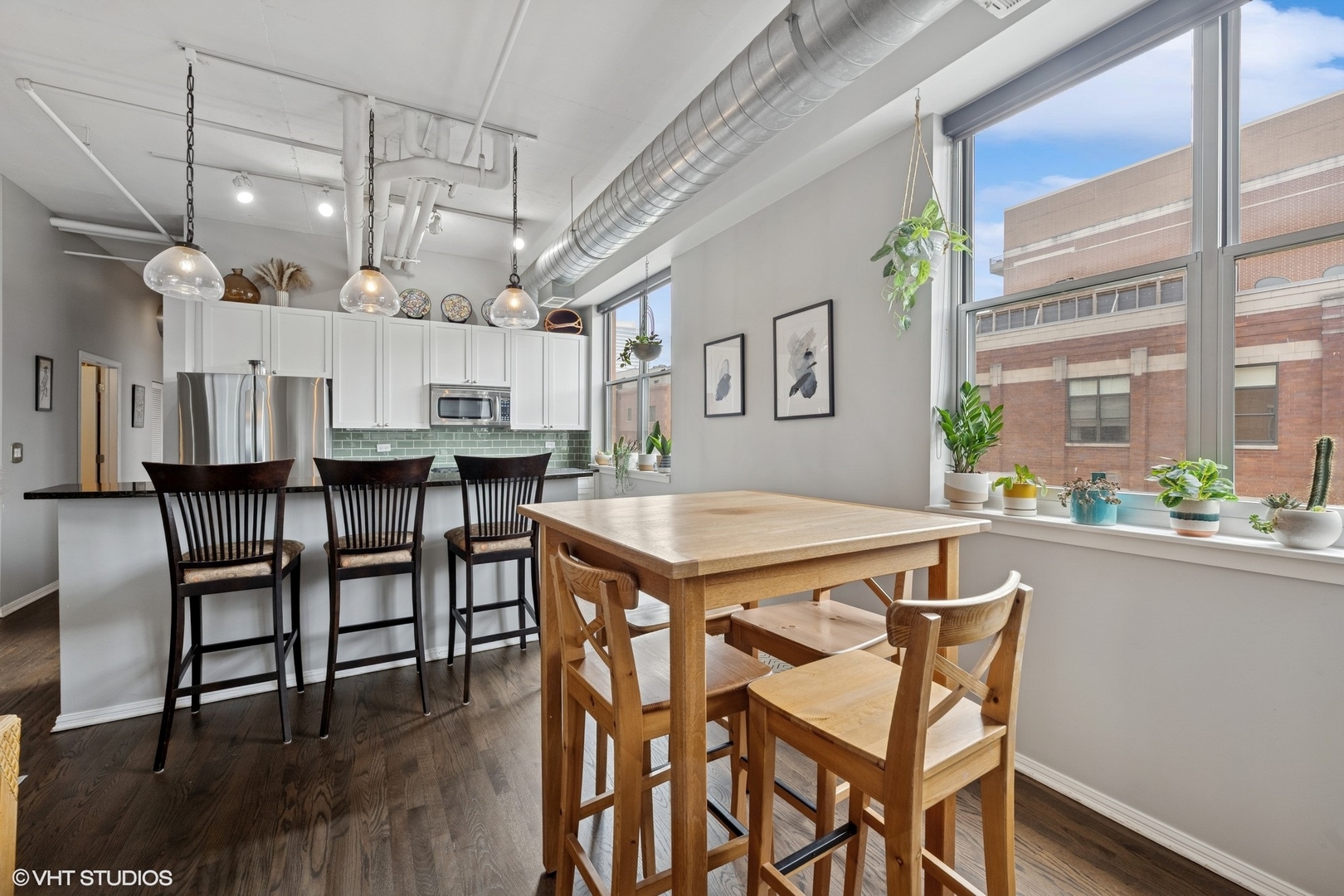 950 West Monroe Street, Unit 410 Chicago, IL 60607 - Photo 6 of 23 a dining table with chairs and wooden floor