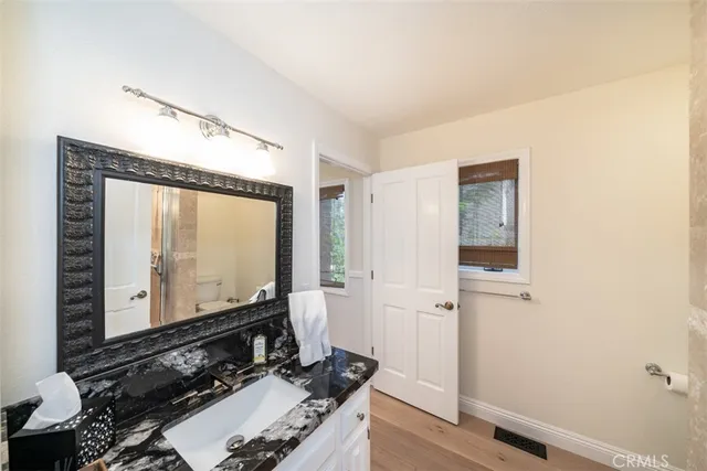 a bathroom with a tub shower and sink