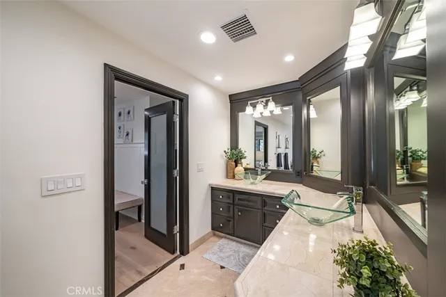 a bathroom with a double vanity sink toilet mirror and shower