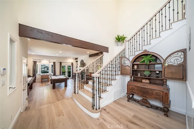 a living room with furniture a fireplace and a chandelier