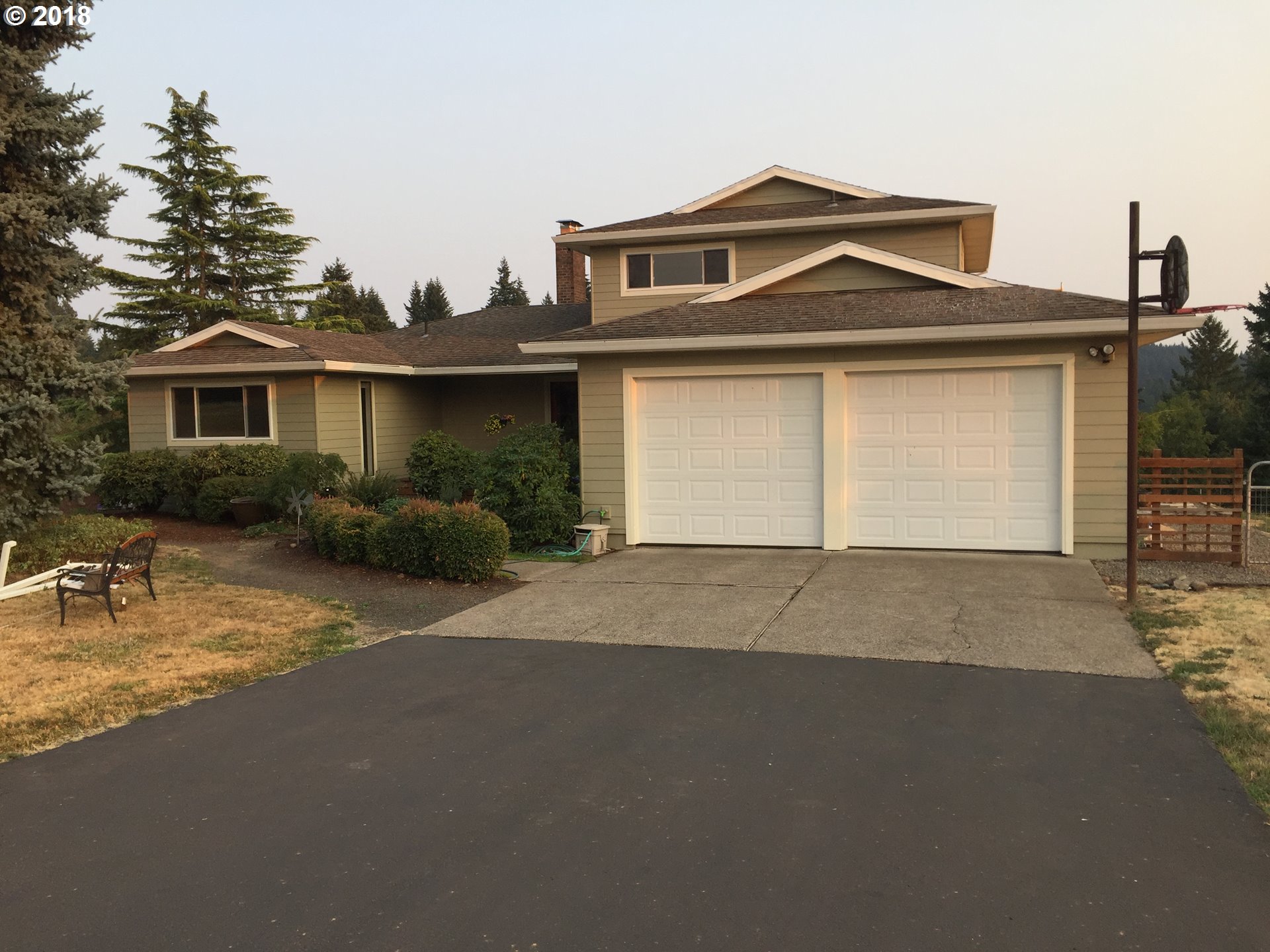 17067 South McCubbin Road Oregon City, OR 97045 - Photo 1 of 32 a front view of a house with a yard and garage