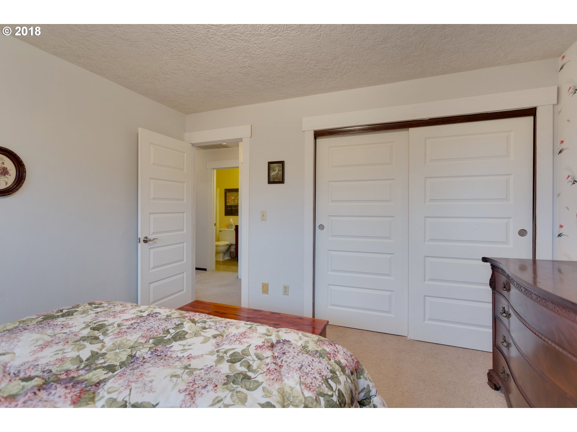 17067 South McCubbin Road Oregon City, OR 97045 - Photo 13 of 32 a bedroom with a bed and a dresser