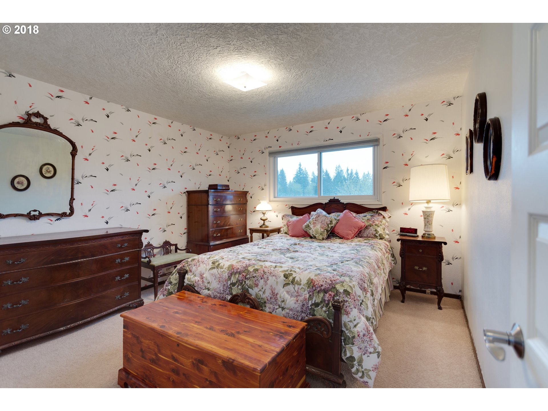 17067 South McCubbin Road Oregon City, OR 97045 - Photo 15 of 32 a bedroom with a bed and wooden floor