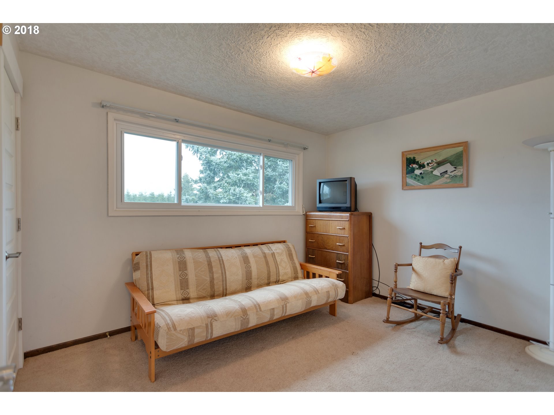 17067 South McCubbin Road Oregon City, OR 97045 - Photo 17 of 32 a living room with a couch and a window