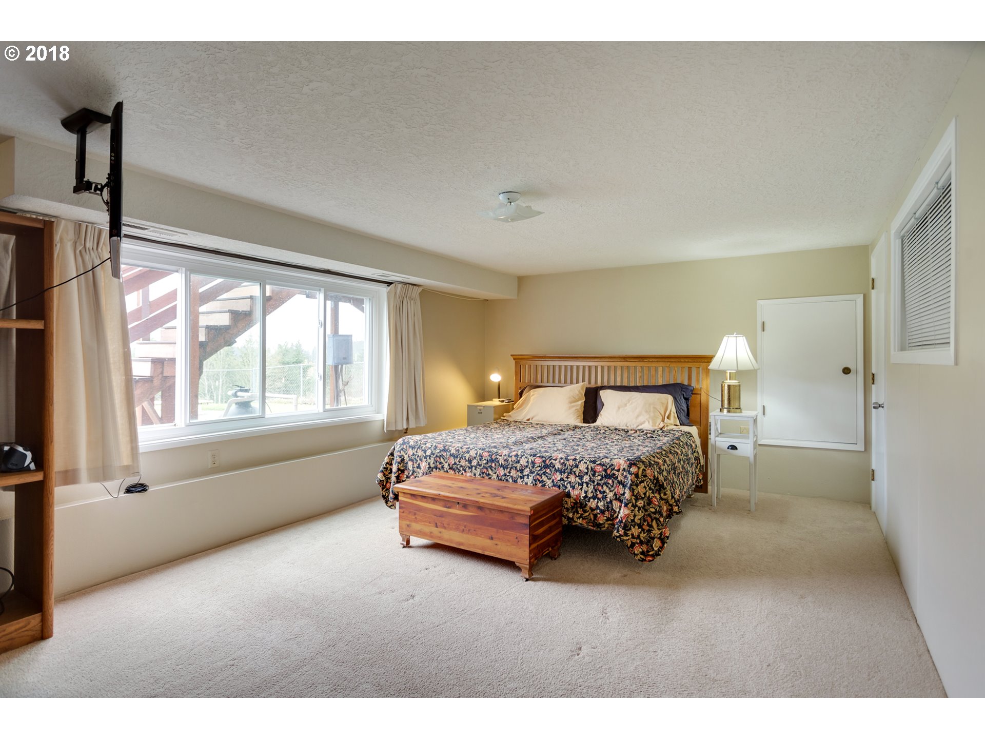 17067 South McCubbin Road Oregon City, OR 97045 - Photo 20 of 32 a bedroom with a large bed and a window