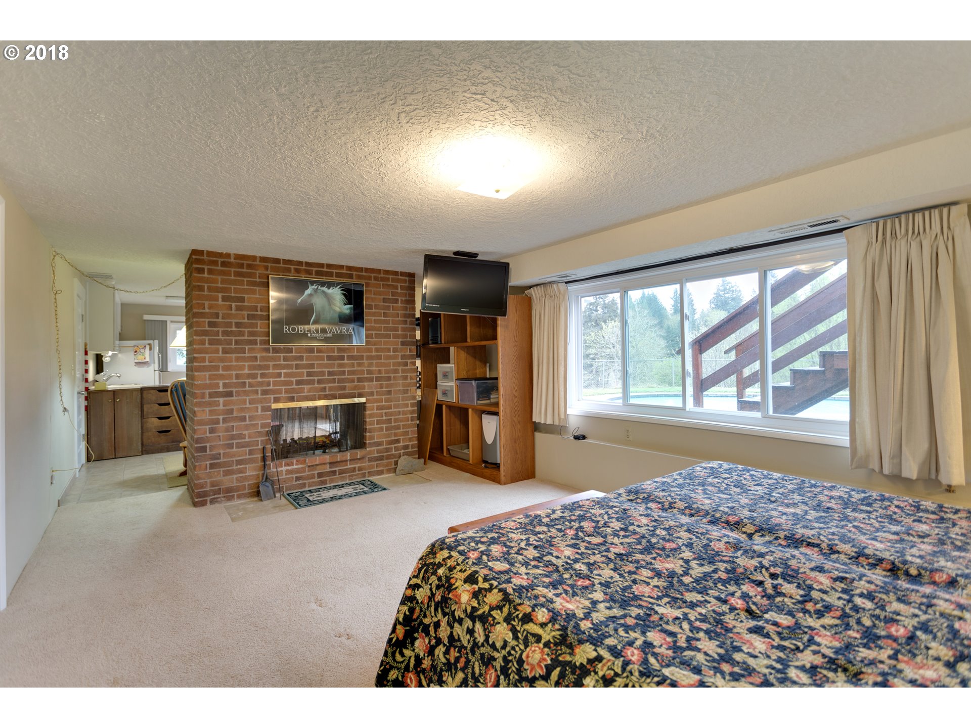 17067 South McCubbin Road Oregon City, OR 97045 - Photo 21 of 32 a bedroom with a bed and a large window