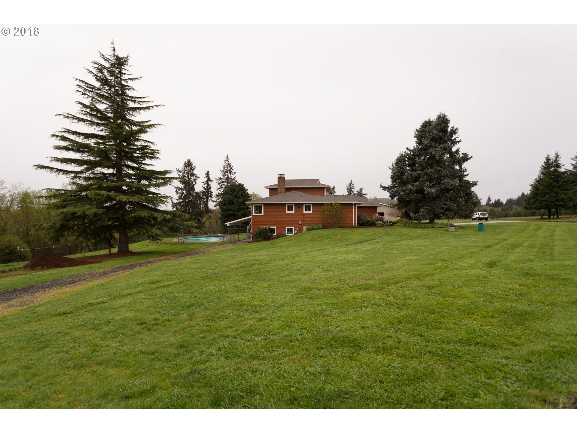 17067 South McCubbin Road Oregon City, OR 97045 - Photo 23 of 32 a car parked in the middle of a field