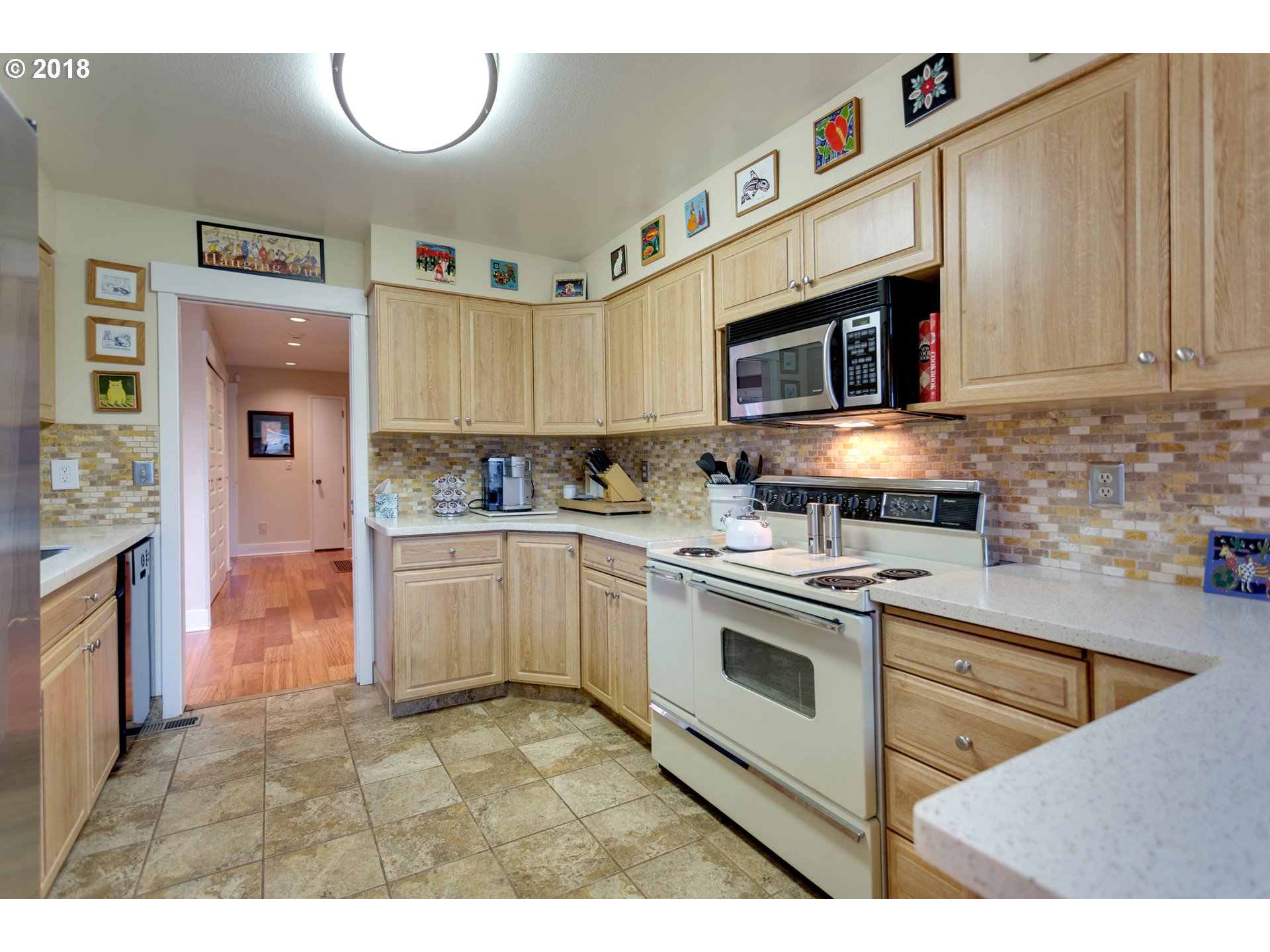 17067 South McCubbin Road Oregon City, OR 97045 - Photo 7 of 32 a kitchen with stainless steel appliances granite countertop a stove a sink and a microwave