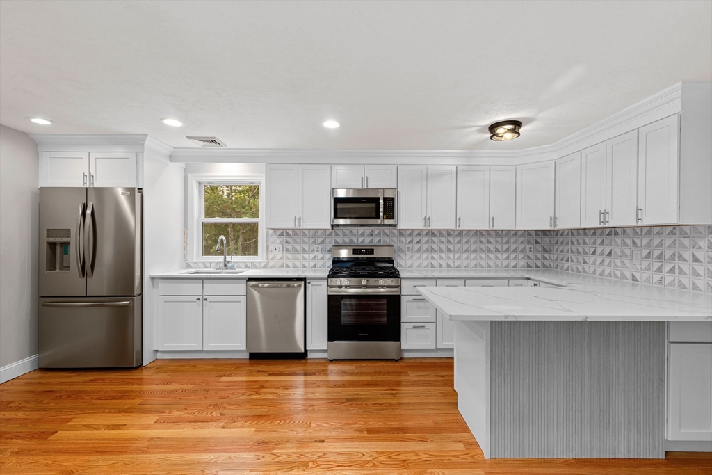 a kitchen with granite countertop a stove and a refrigerator