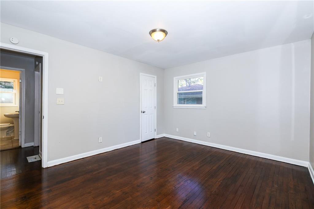 4572 Campbellton Road Southwest Atlanta, GA 30331 - Photo 12 of 21 a view of an empty room with wooden floor and a window