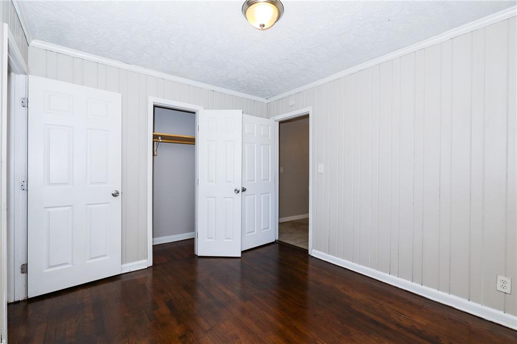 4572 Campbellton Road Southwest Atlanta, GA 30331 - Photo 13 of 21 a view of an empty room with wooden floor and windows