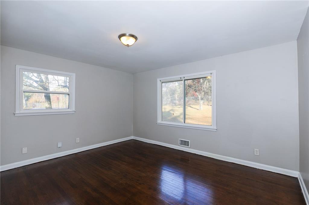 4572 Campbellton Road Southwest Atlanta, GA 30331 - Photo 14 of 21 a view of an empty room with wooden floor and a window