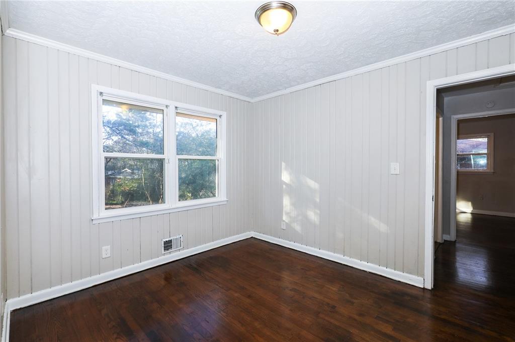 4572 Campbellton Road Southwest Atlanta, GA 30331 - Photo 15 of 21 an empty room with wooden floor and windows