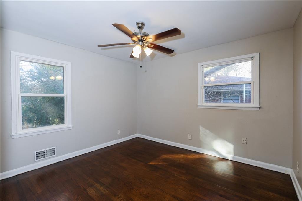 4572 Campbellton Road Southwest Atlanta, GA 30331 - Photo 17 of 21 a view of an empty room with wooden floor and a window