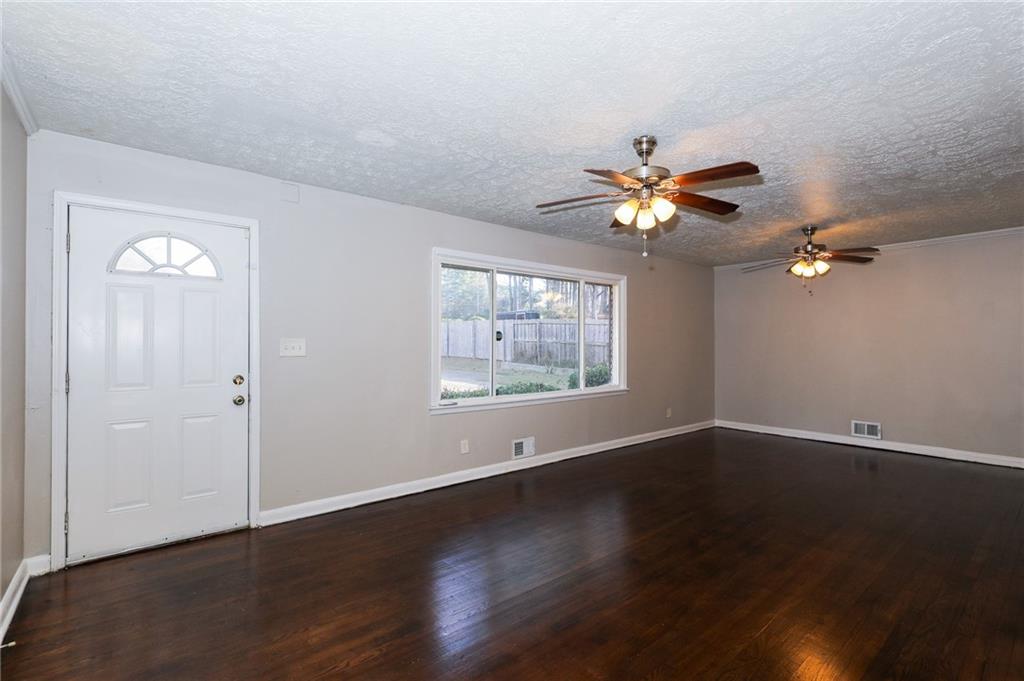 4572 Campbellton Road Southwest Atlanta, GA 30331 - Photo 4 of 21 a view of an empty room with wooden floor and a window