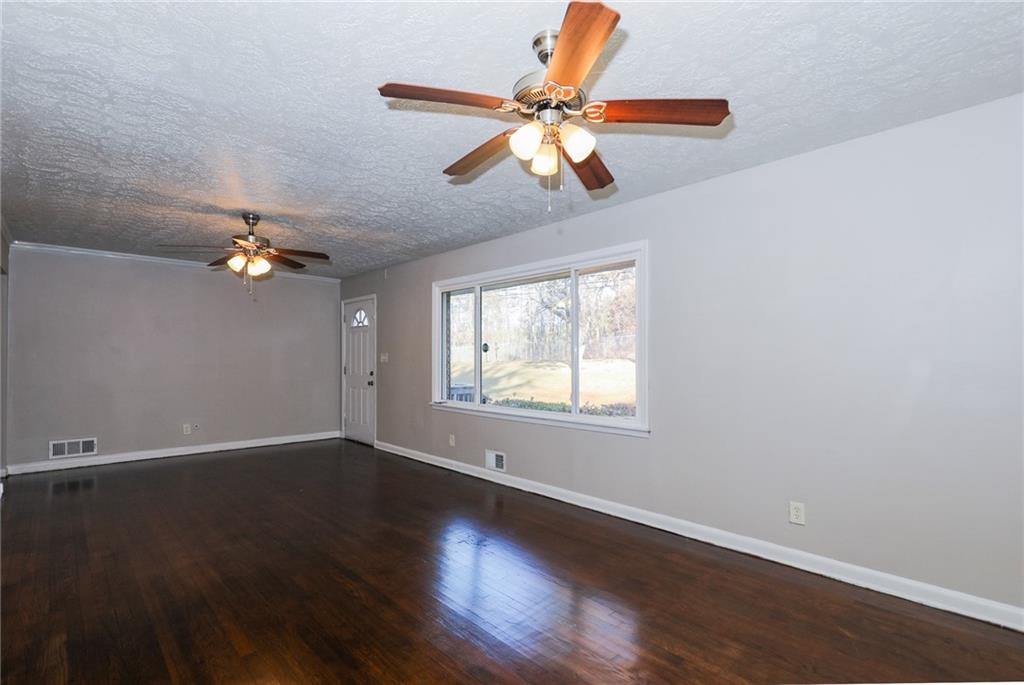 4572 Campbellton Road Southwest Atlanta, GA 30331 - Photo 6 of 21 a view of an empty room with wooden floor and a window