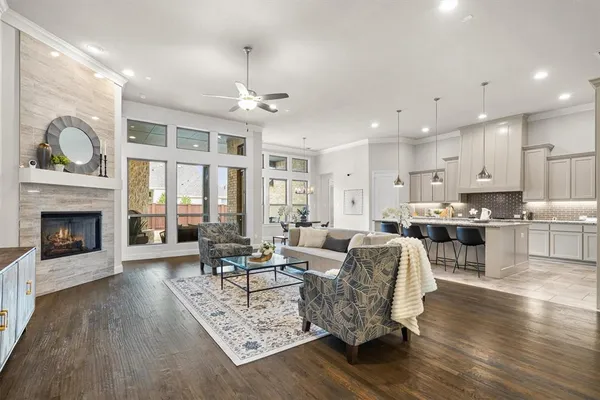 a living room with furniture wooden floor and a fireplace