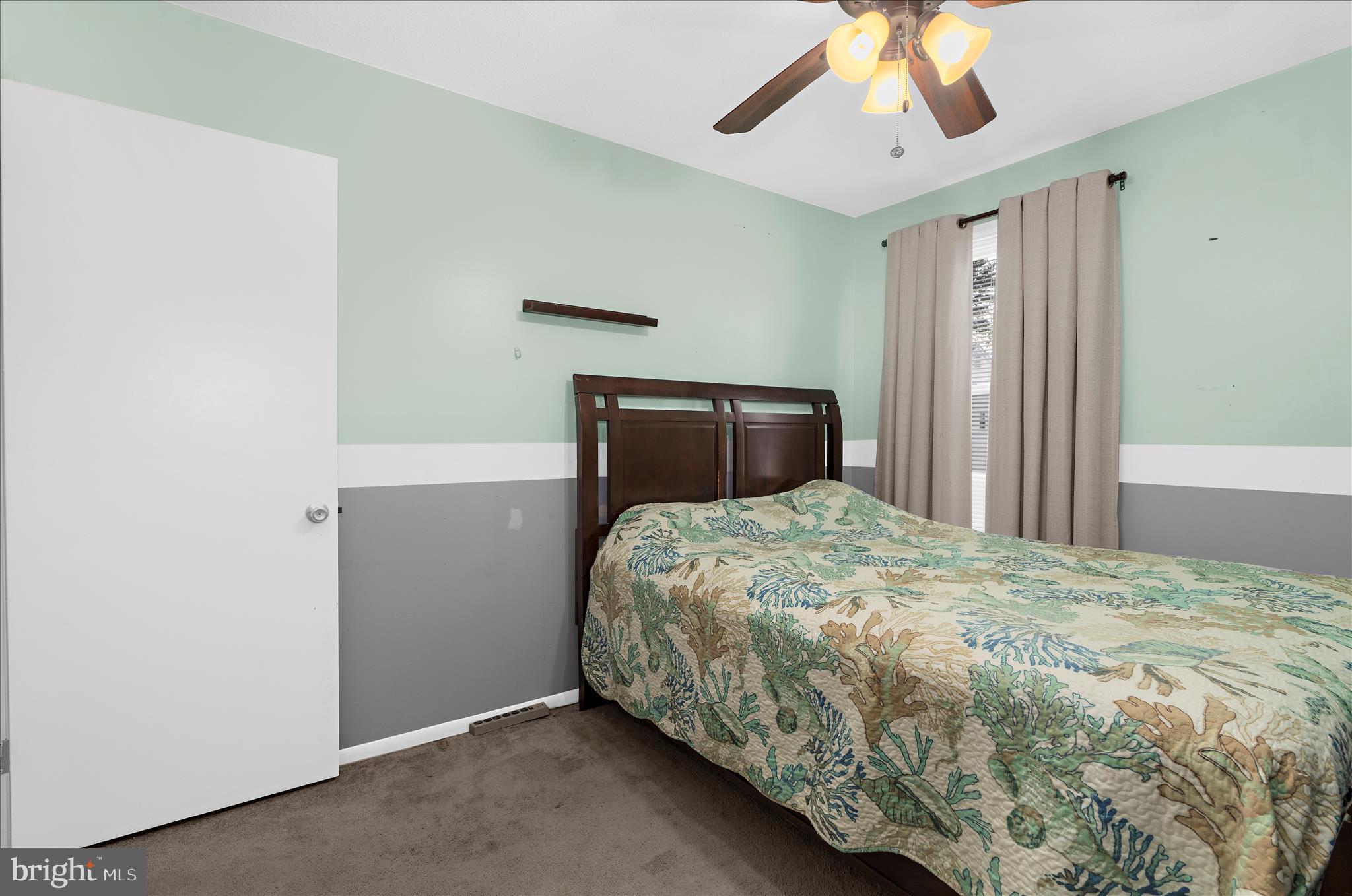 2313 230th Street Pasadena, MD 21122 - Photo 13 of 35 a bedroom with a bed and a chandelier
