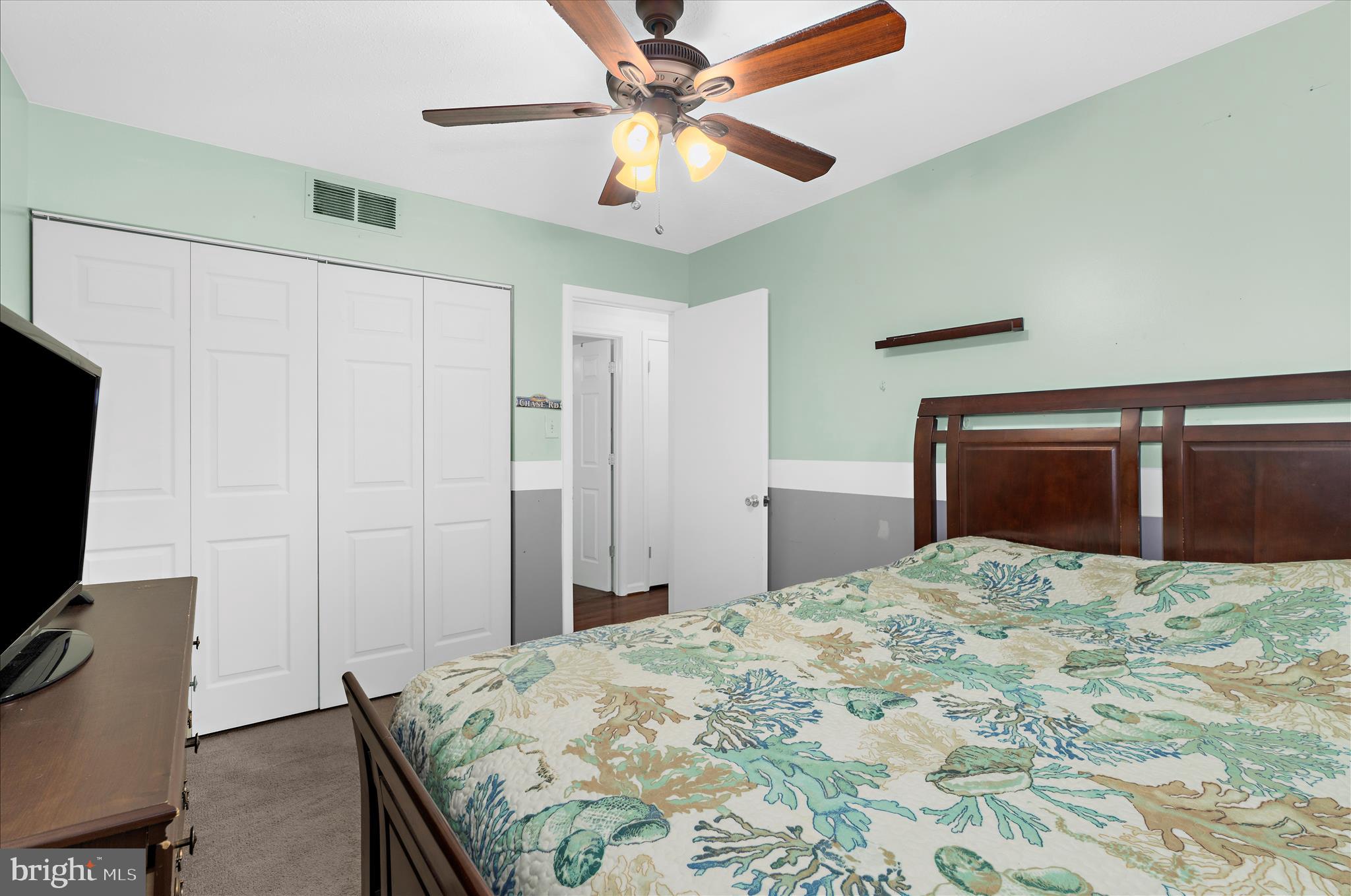2313 230th Street Pasadena, MD 21122 - Photo 14 of 35 a bedroom with a bed and a television
