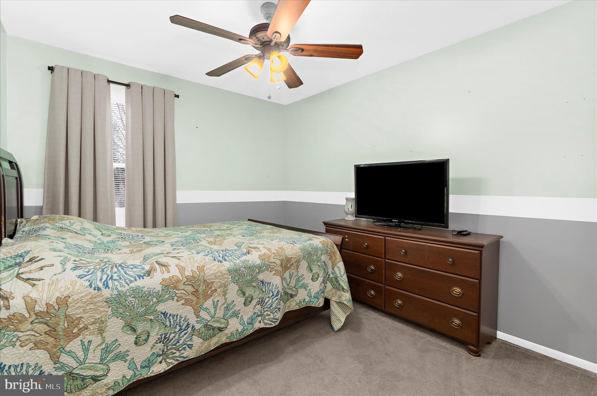 2313 230th Street Pasadena, MD 21122 - Photo 15 of 35 a bedroom with a bed and a flat screen tv