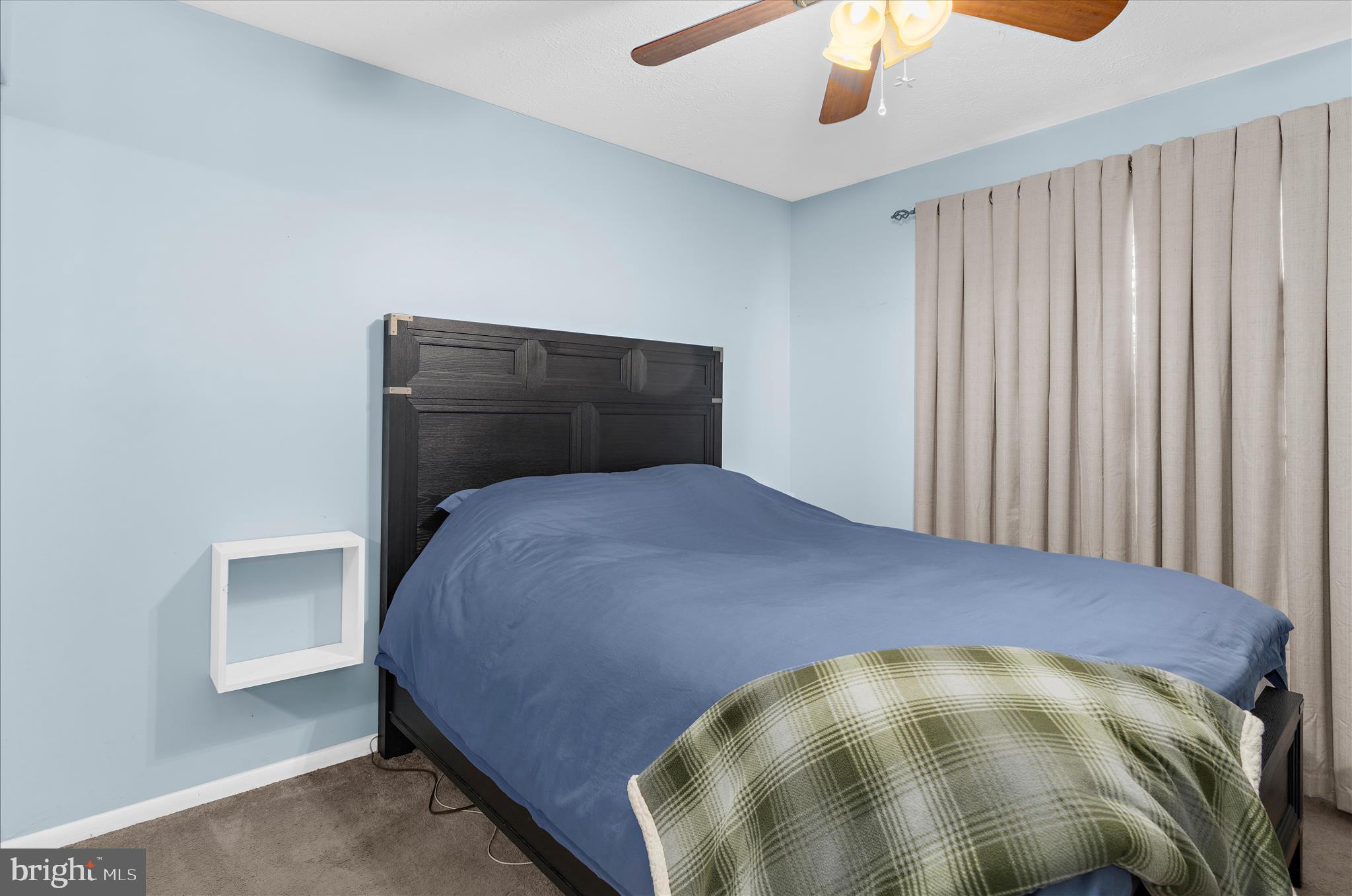 2313 230th Street Pasadena, MD 21122 - Photo 16 of 35 a bedroom with a bed and a chandelier
