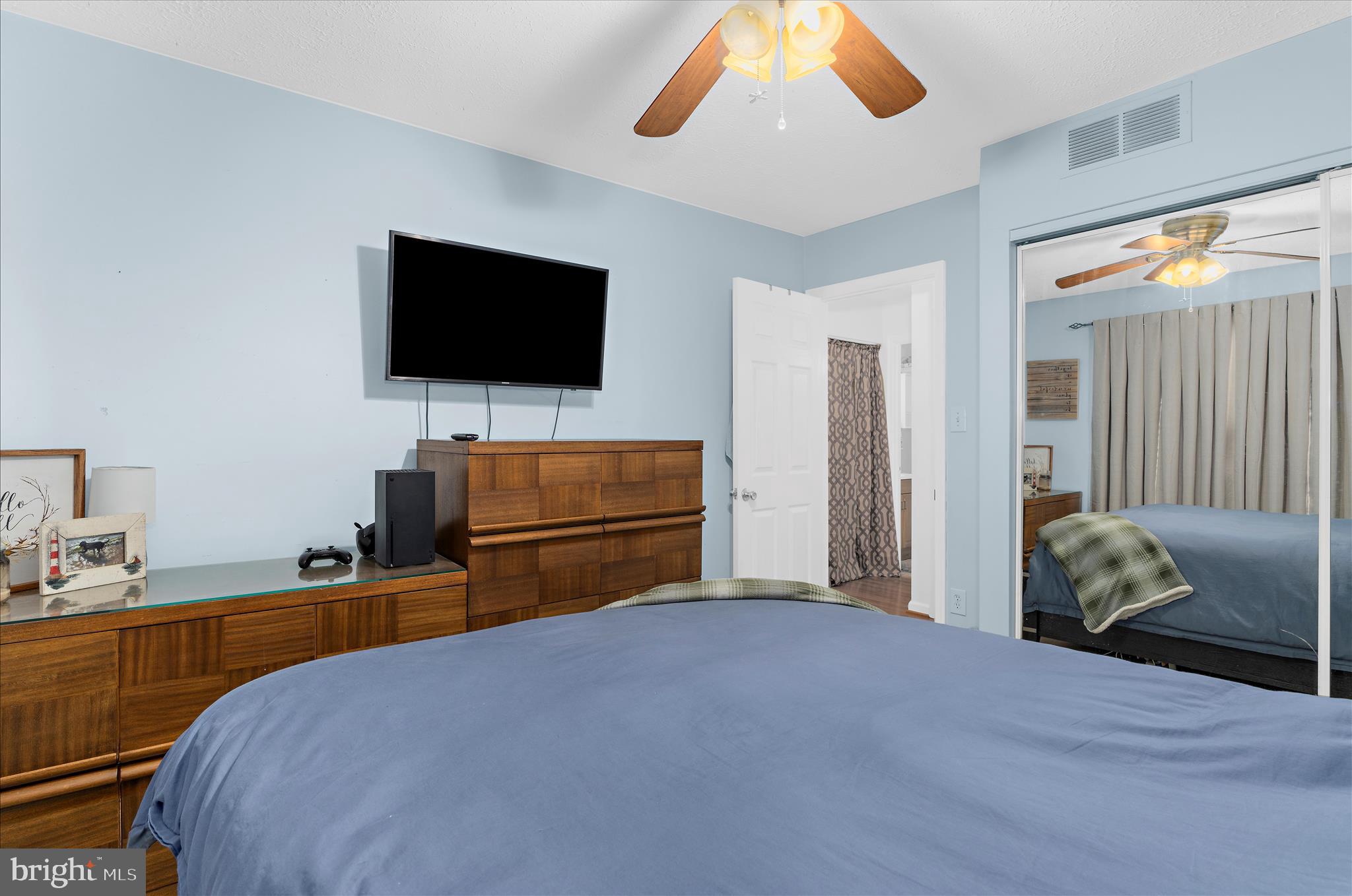 2313 230th Street Pasadena, MD 21122 - Photo 18 of 35 a bedroom with a bed and flat screen tv