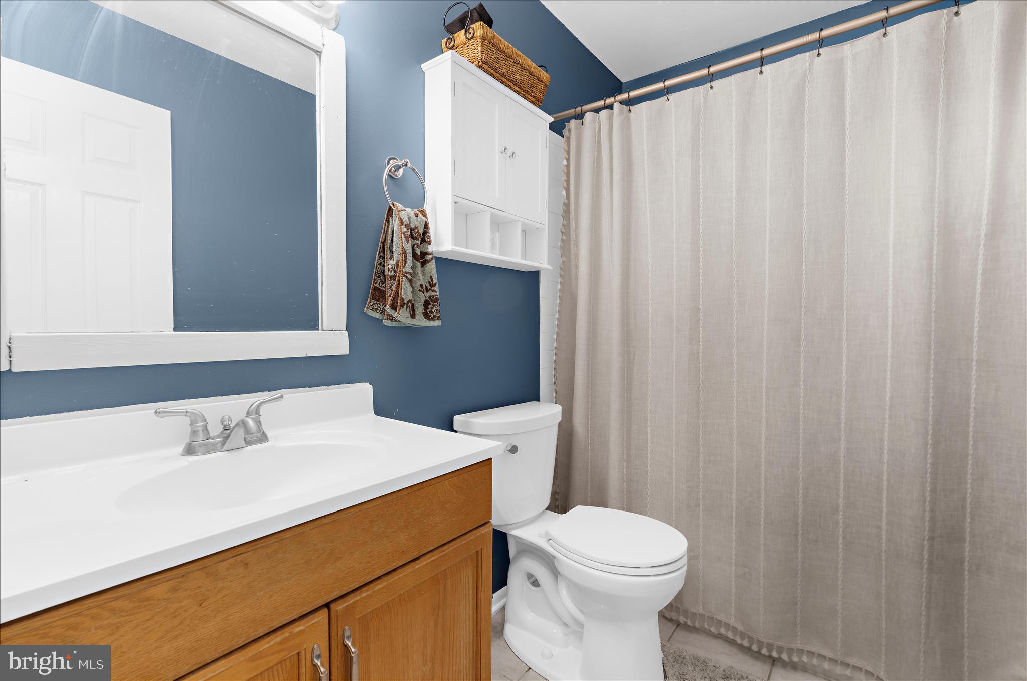 2313 230th Street Pasadena, MD 21122 - Photo 19 of 35 a bathroom with a sink a toilet and shower curtain
