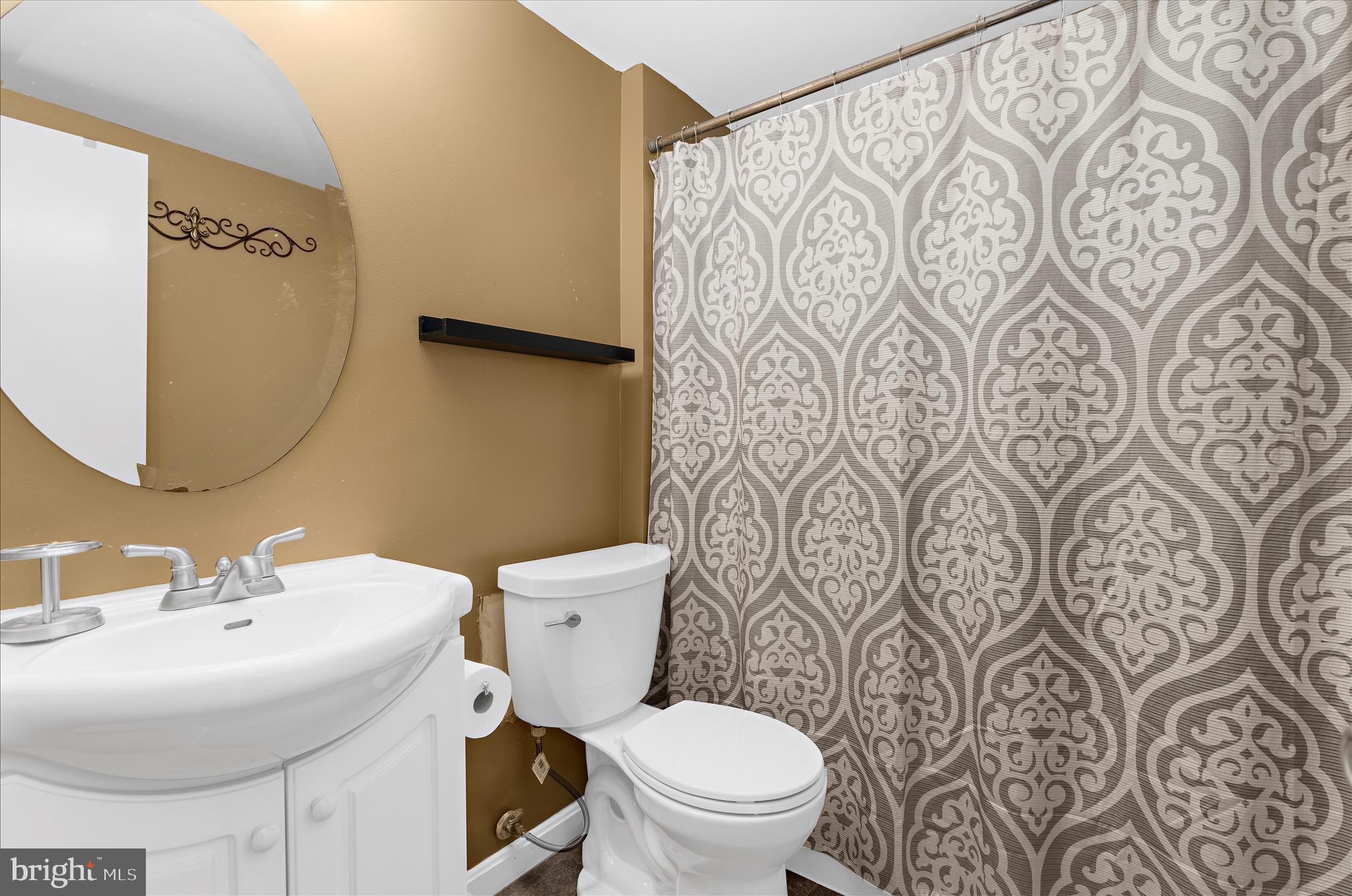 2313 230th Street Pasadena, MD 21122 - Photo 26 of 35 a bathroom with a sink and mirror with toilet