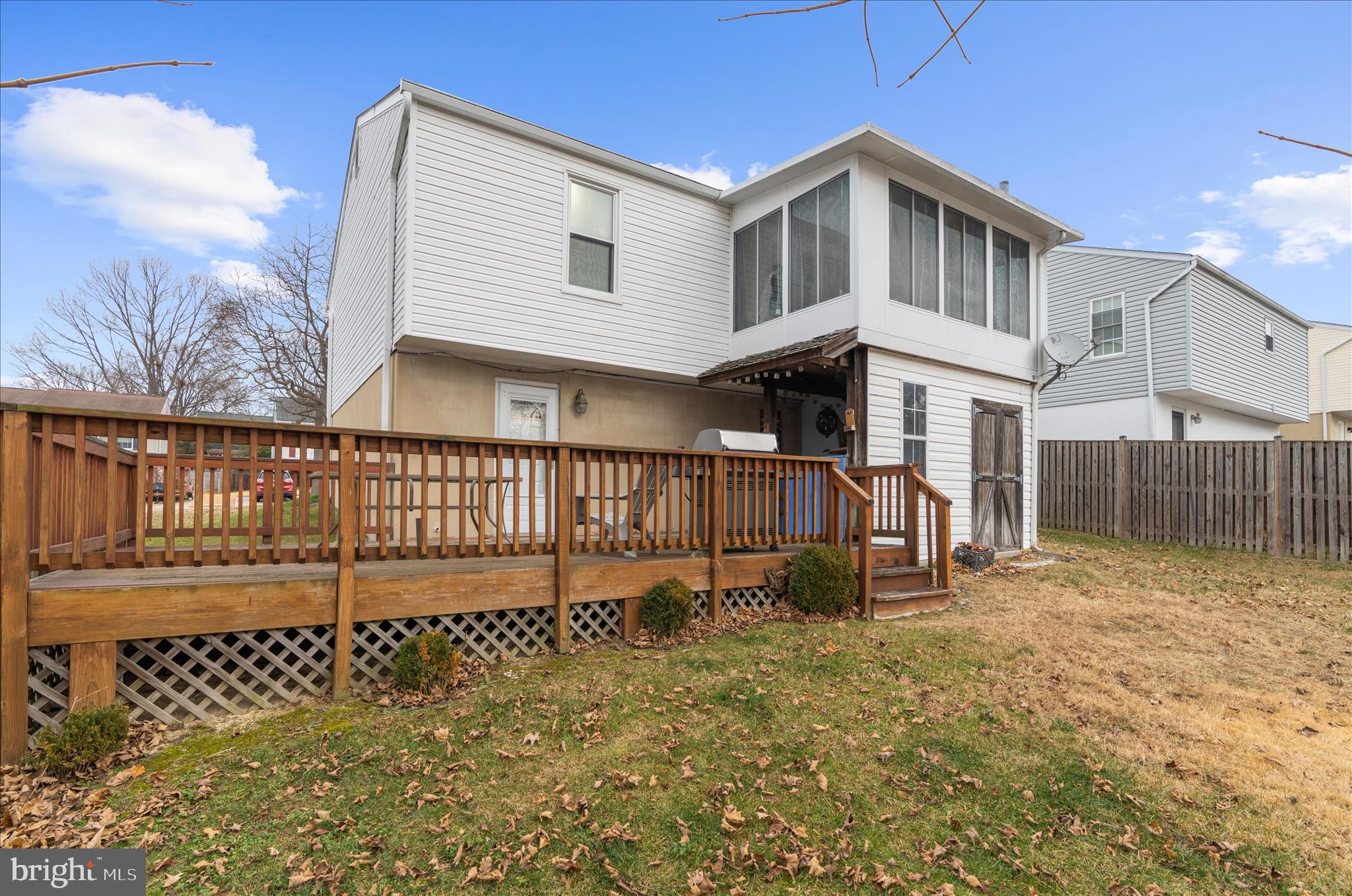 2313 230th Street Pasadena, MD 21122 - Photo 29 of 35 a white house that has a small yard and wooden fence