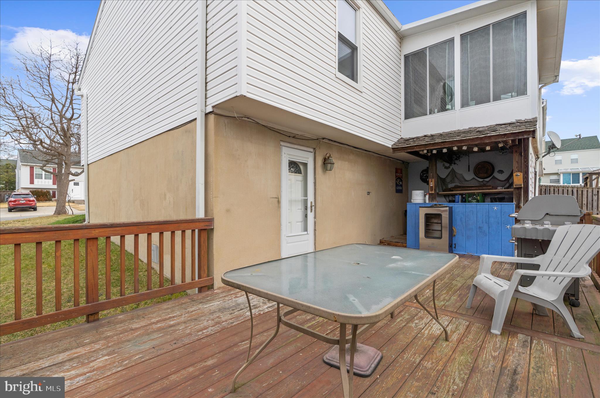 2313 230th Street Pasadena, MD 21122 - Photo 32 of 35 a view of a house with wooden deck and furniture