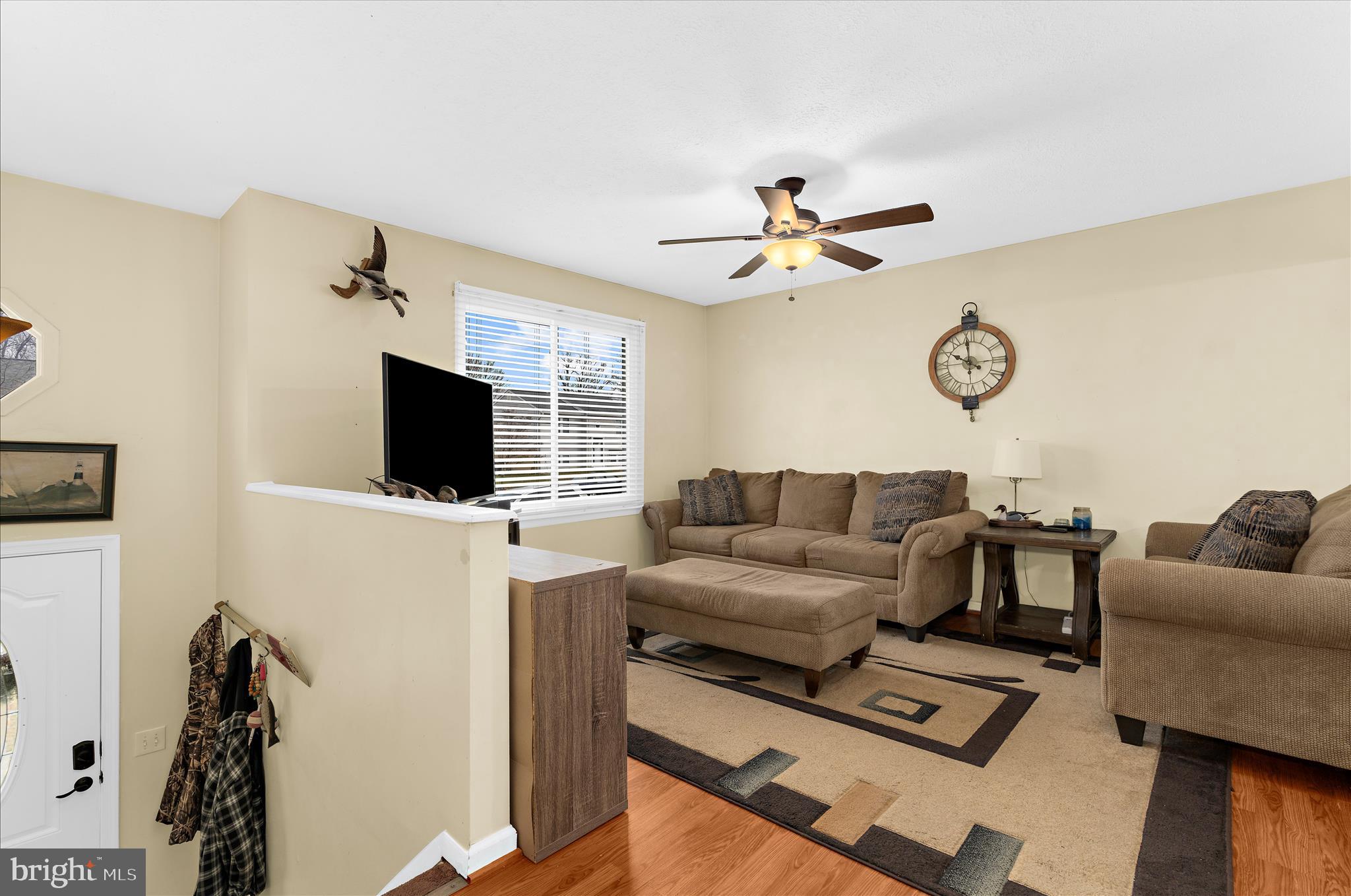 2313 230th Street Pasadena, MD 21122 - Photo 4 of 35 a living room with furniture a flat screen tv and a fireplace