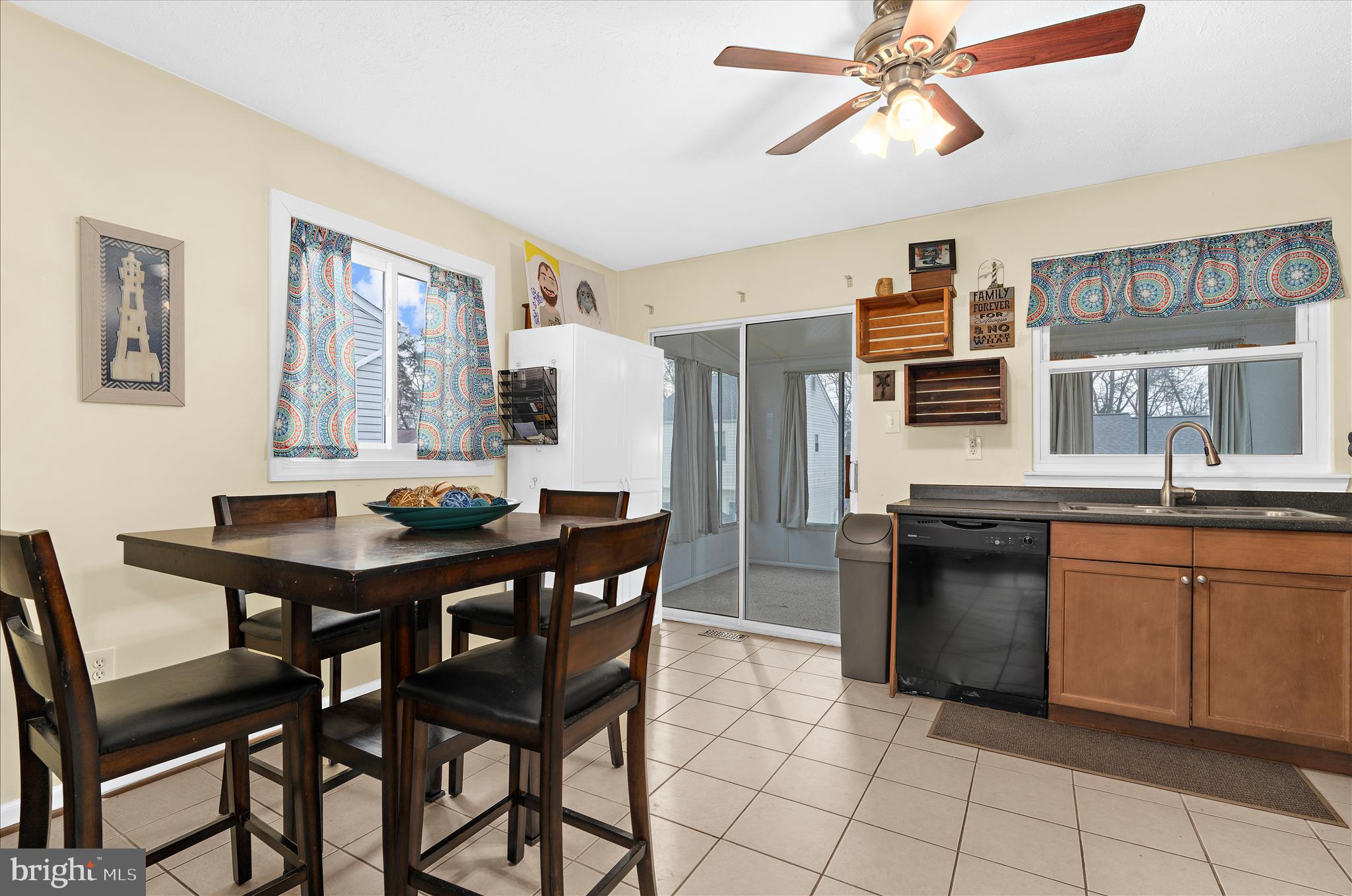 2313 230th Street Pasadena, MD 21122 - Photo 7 of 35 a kitchen with stainless steel appliances kitchen island granite countertop a dining table chairs and a refrigerator