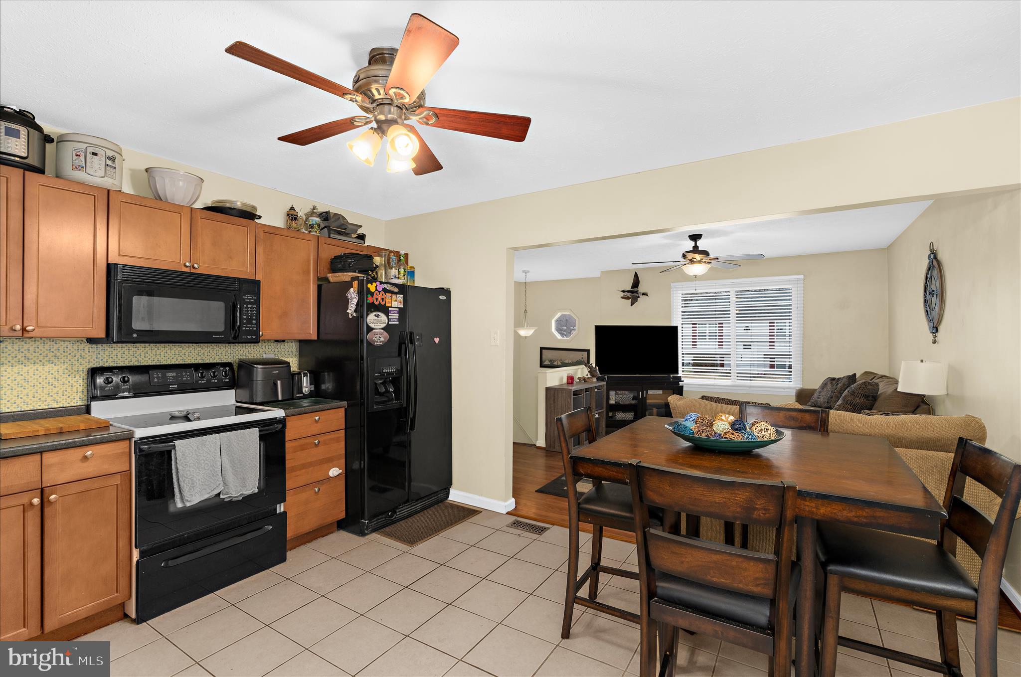 2313 230th Street Pasadena, MD 21122 - Photo 8 of 35 a kitchen with a dining table and chairs