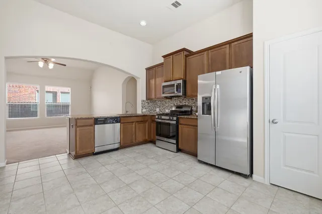 a spacious bedroom with a bed and glass window