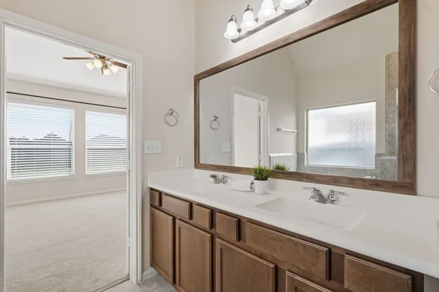 a bathroom with a tub sink and mirror