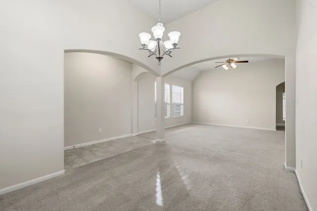 a view of an empty room with a kitchen