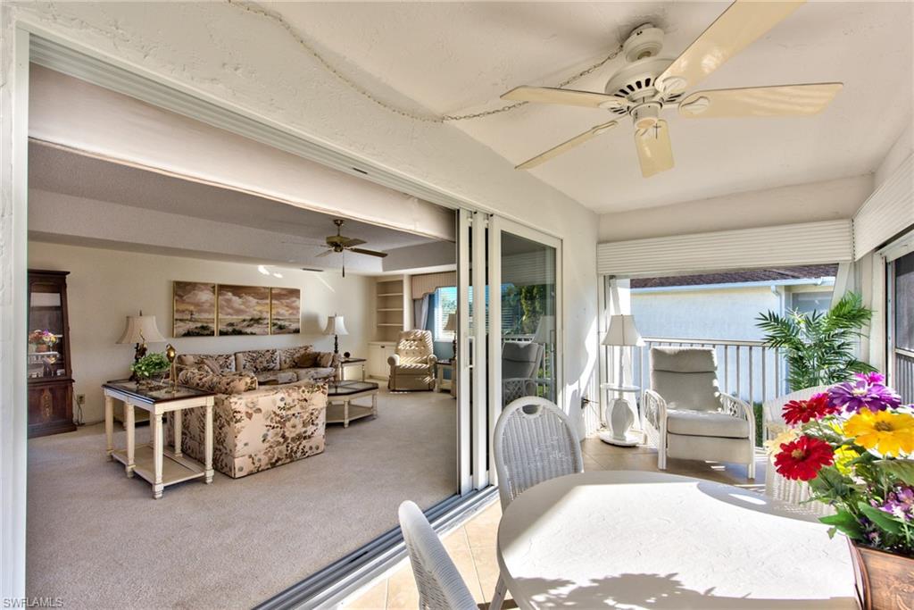 865 Teryl Road, Unit 2114 Naples, FL 34112 - Photo 1 of 26 a living room with furniture and a flat screen tv