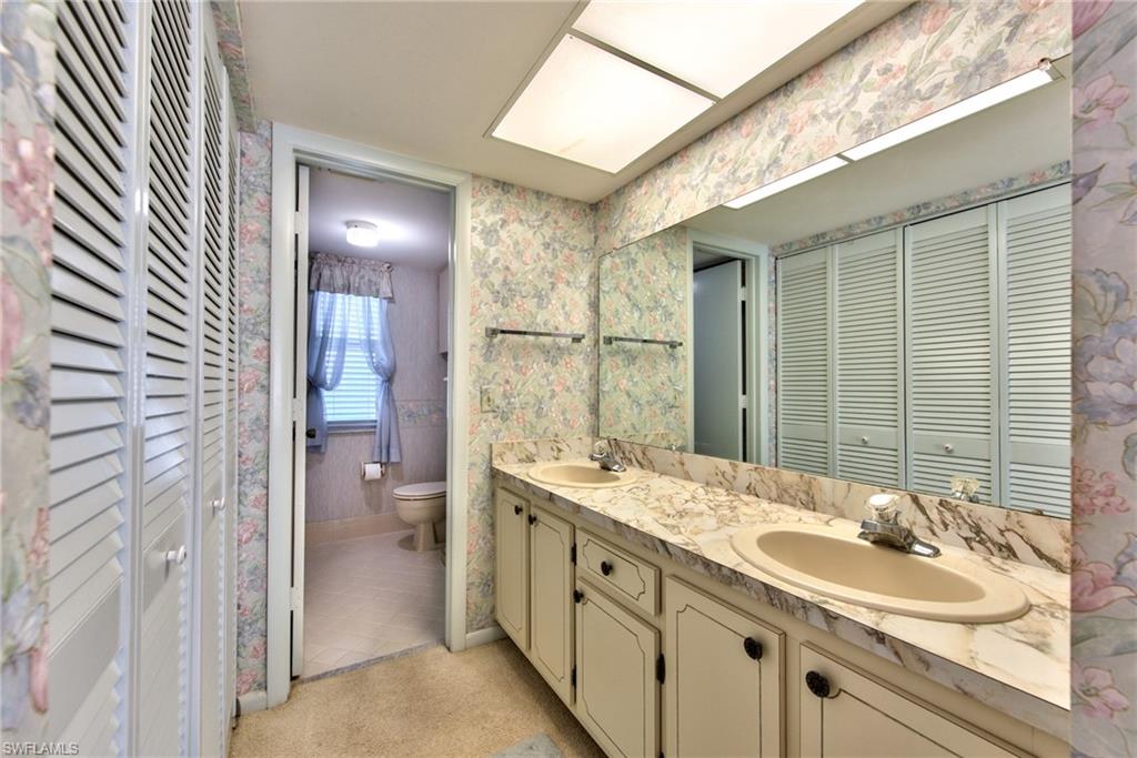 865 Teryl Road, Unit 2114 Naples, FL 34112 - Photo 14 of 26 a bathroom with a sink double vanity and a mirror