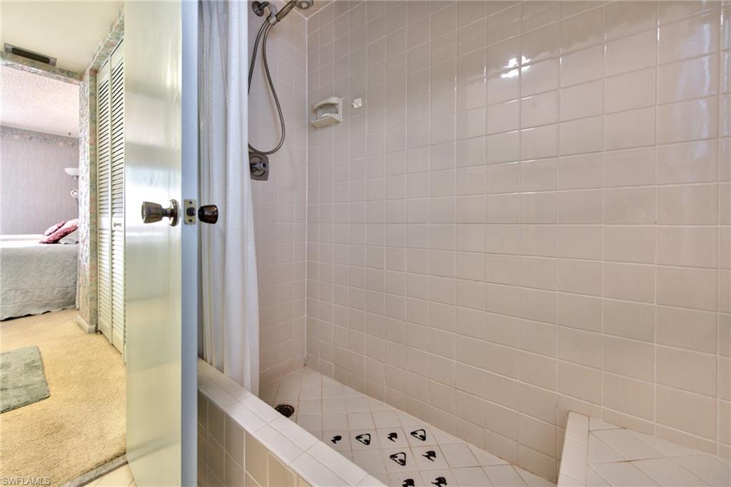 865 Teryl Road, Unit 2114 Naples, FL 34112 - Photo 15 of 26 a bathroom with a bathtub and a shower