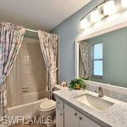 865 Teryl Road, Unit 2114 Naples, FL 34112 - Photo 17 of 26 a bathroom with a granite countertop sink toilet and a mirror