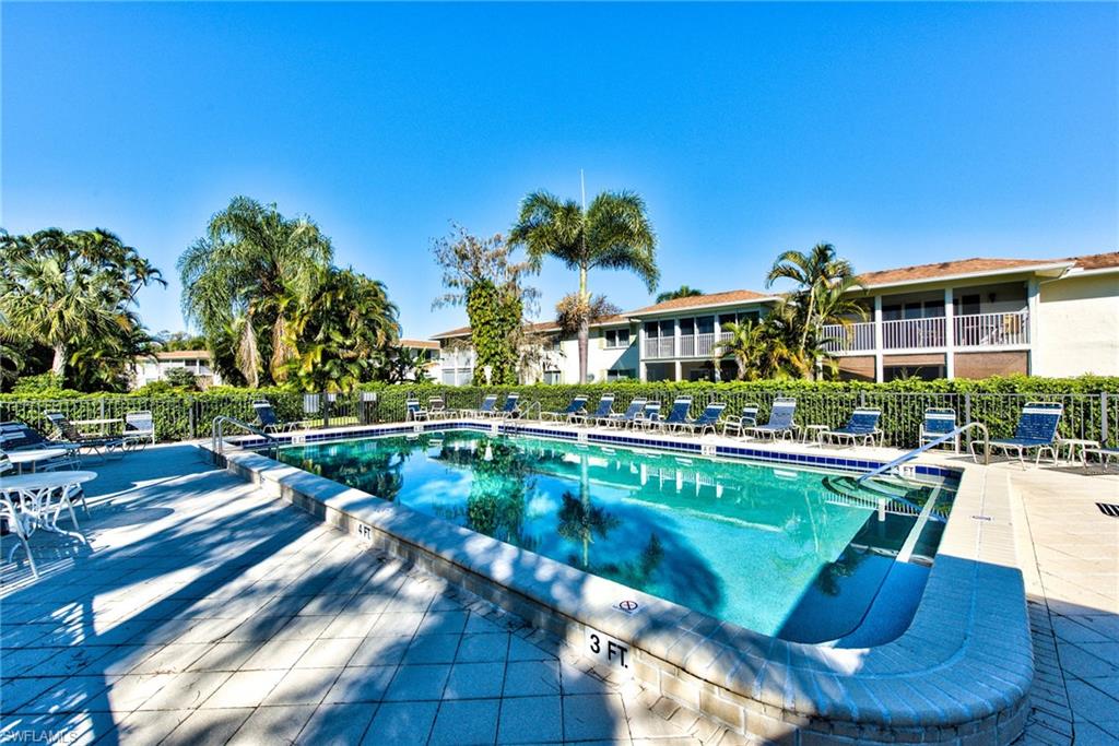 865 Teryl Road, Unit 2114 Naples, FL 34112 - Photo 19 of 26 a view of a swimming pool with lounge chairs