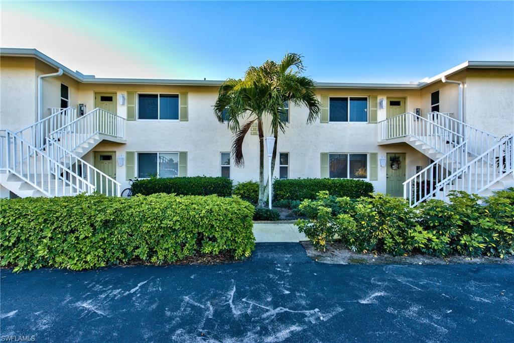 865 Teryl Road, Unit 2114 Naples, FL 34112 - Photo 21 of 26 a front view of a house with a garden