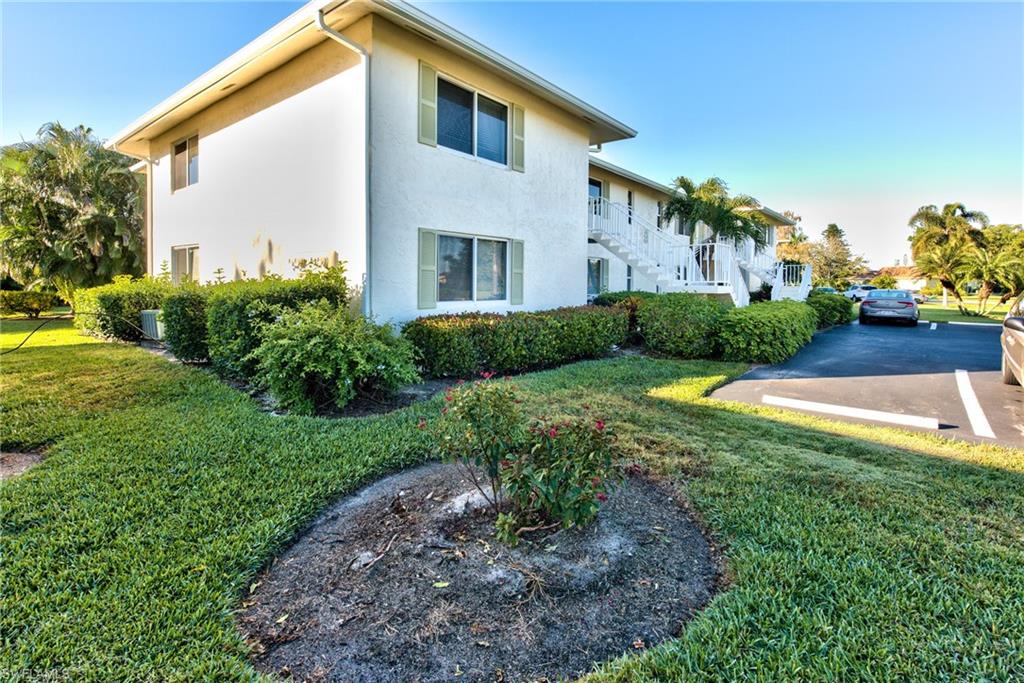 865 Teryl Road, Unit 2114 Naples, FL 34112 - Photo 22 of 26 a front view of a house with garden