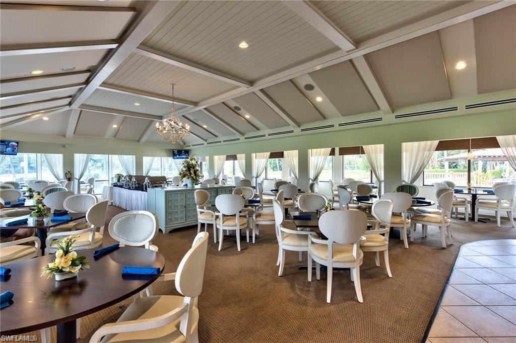 865 Teryl Road, Unit 2114 Naples, FL 34112 - Photo 25 of 26 a dining room with lots of tables a large window and chairs