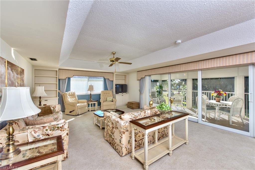 865 Teryl Road, Unit 2114 Naples, FL 34112 - Photo 4 of 26 a living room with furniture and a large window