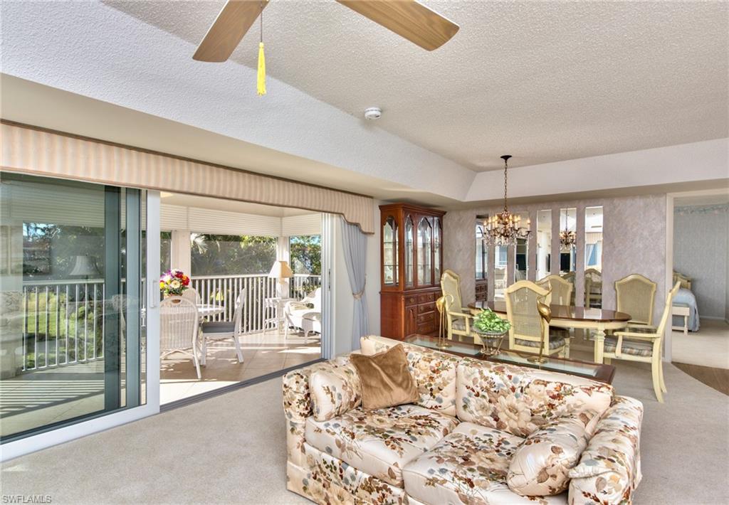 865 Teryl Road, Unit 2114 Naples, FL 34112 - Photo 6 of 26 a living room with furniture large window and wooden floor