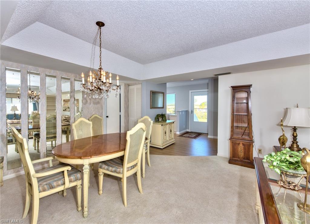 865 Teryl Road, Unit 2114 Naples, FL 34112 - Photo 8 of 26 a view of a dining room with furniture window and wooden floor